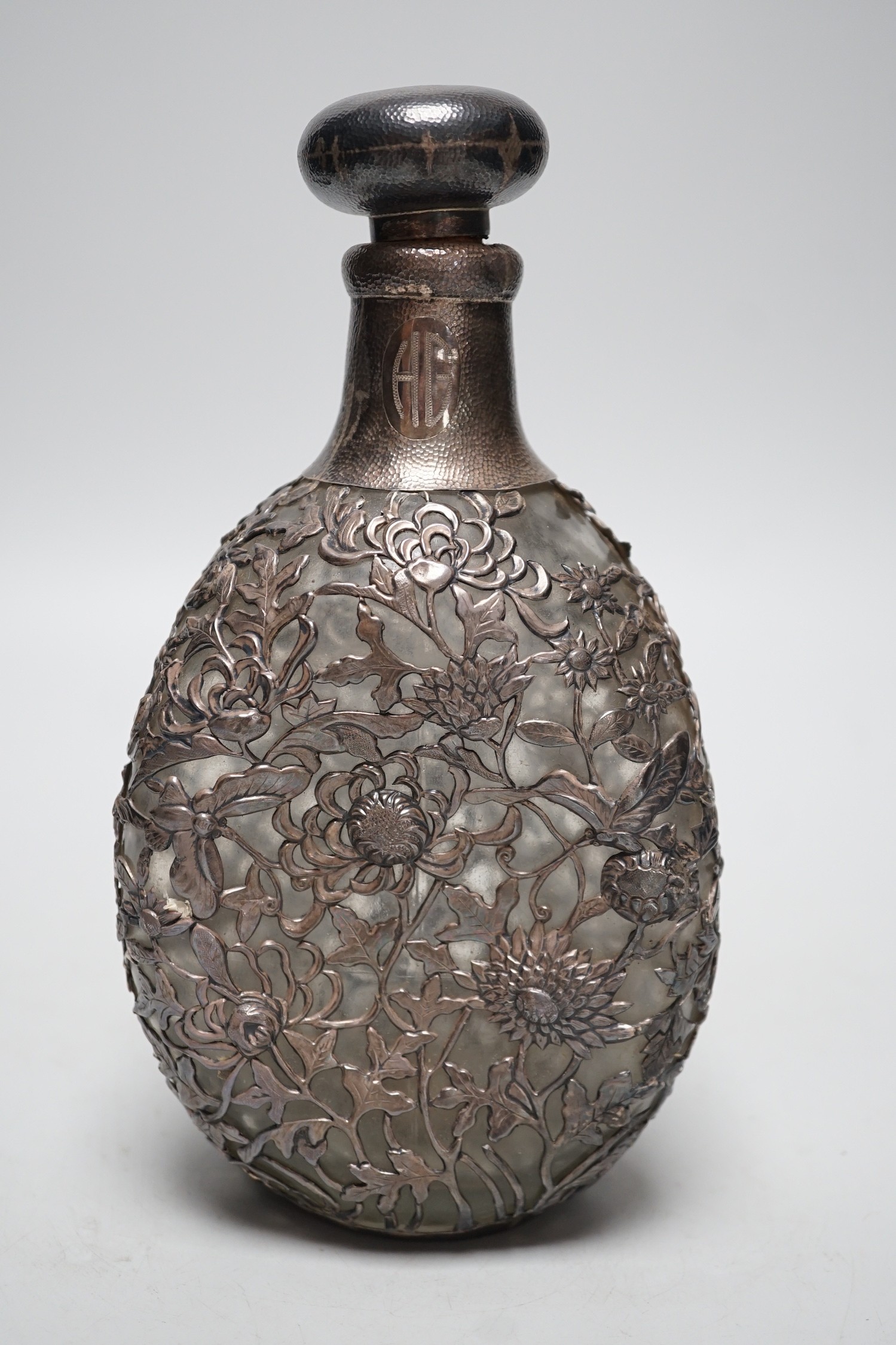 A Chinese planished white metal mounted dimpled decanter and stopper, by Yeching, 23.5cm.